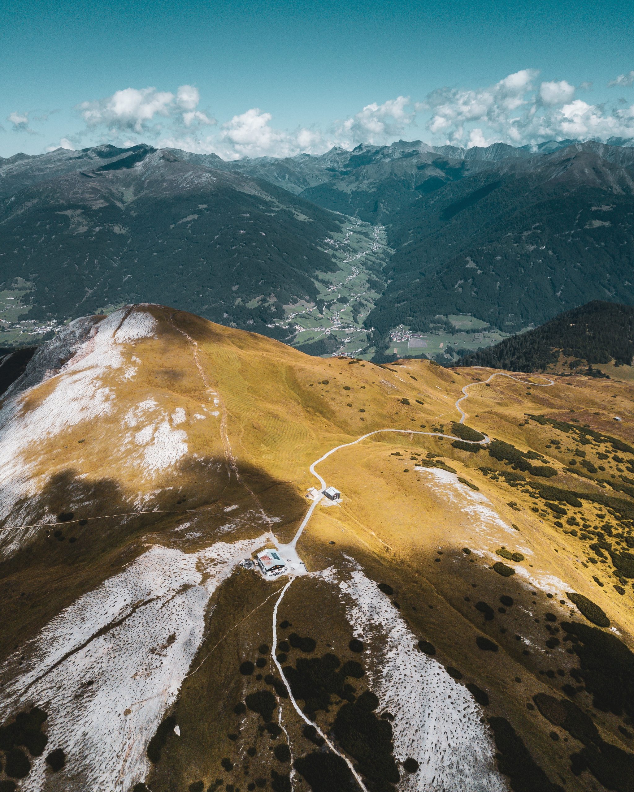 Beautiful bird-eye vertical scenery of mountains and a lonesome house